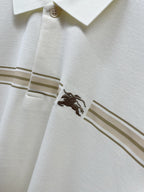 Burberry polo shirt side seam with horse emblem and tan stripe accent
