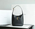 Black YSL shoulder bag with gold YSL logo charm and top handles