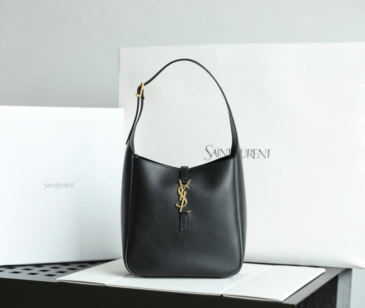 Black YSL shoulder bag with gold YSL logo charm and top handles