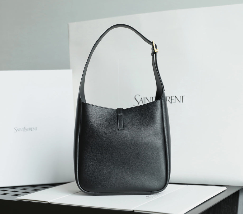 Black YSL shoulder bag with gold YSL logo charm and front slot pocket