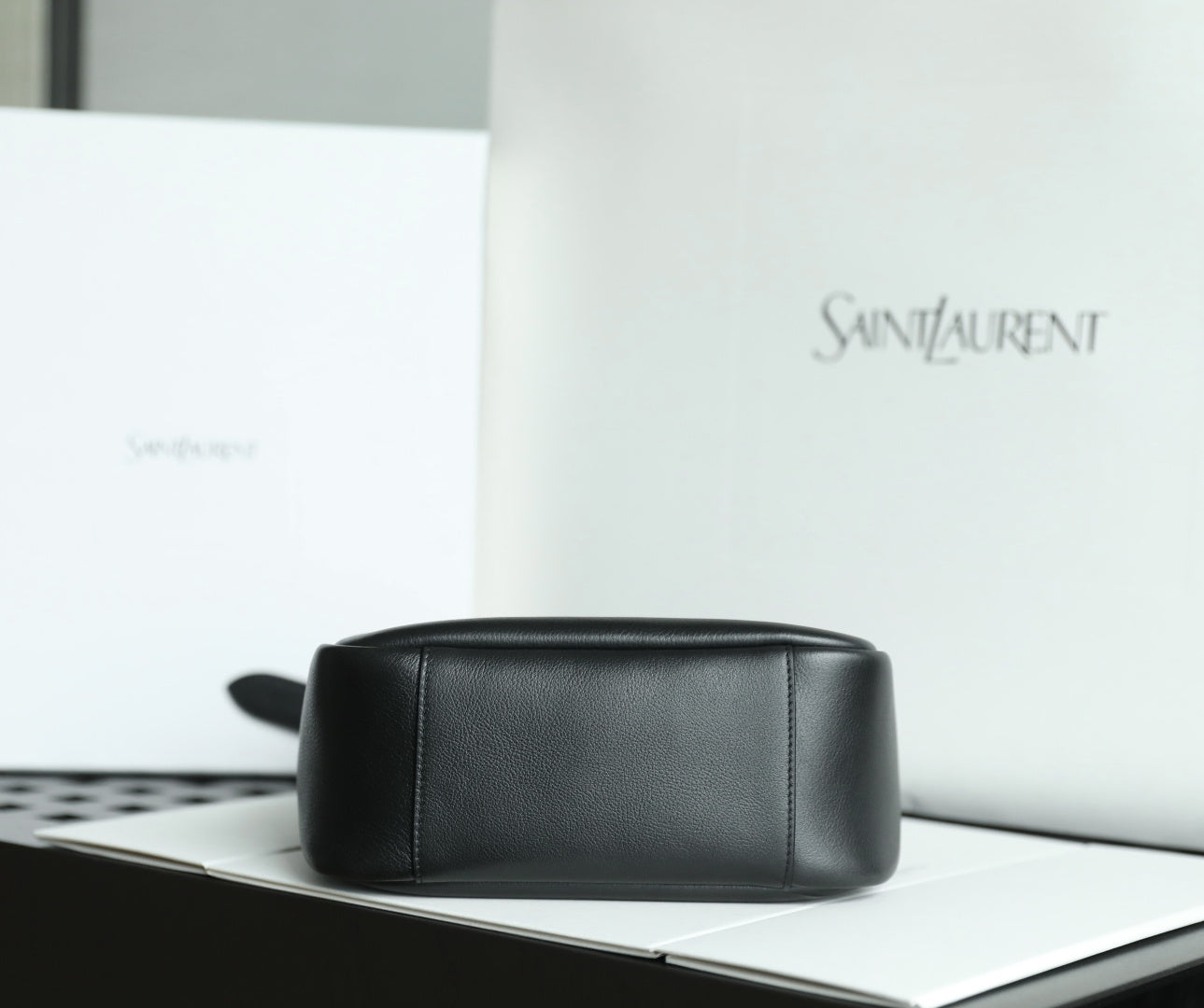 Black YSL bag with top zip closure and smooth rectangular front