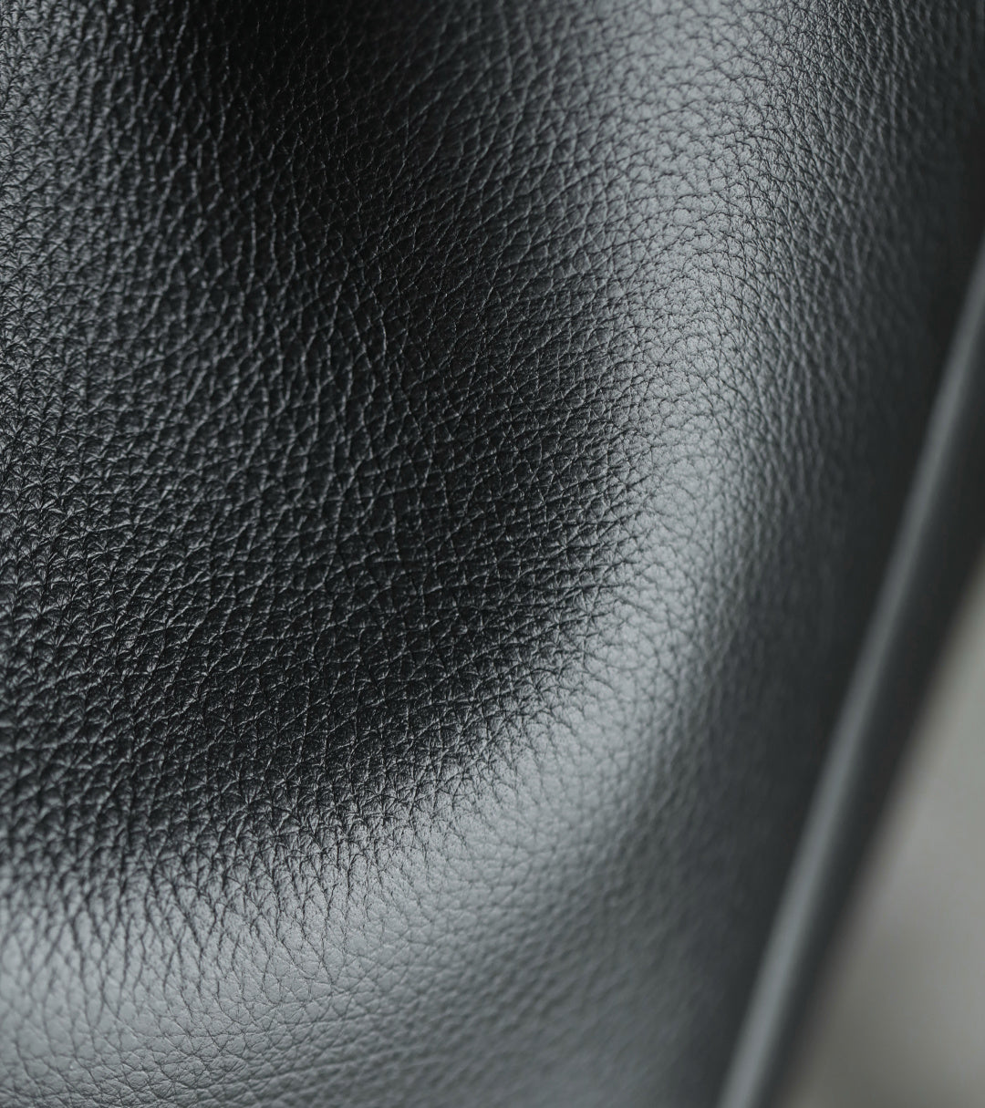 Black pebbled leather panel detail on a YSL bag