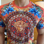 Graphic print T-shirt close-up of Medusa medallion with blue gem accents, red-orange