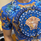Blue graphic T-shirt close-up: circular Medusa portrait with swirl and floral motifs