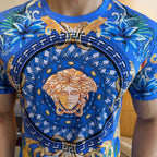 Blue graphic T-shirt close-up of Medusa portrait emblem with ornate geometric border