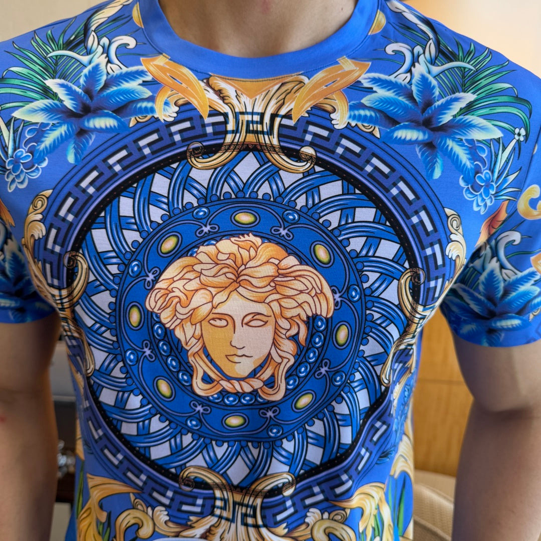 Blue graphic T-shirt close-up of Medusa portrait emblem with ornate geometric border