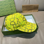 Yellow GG-print baseball cap with curved brim, front view.