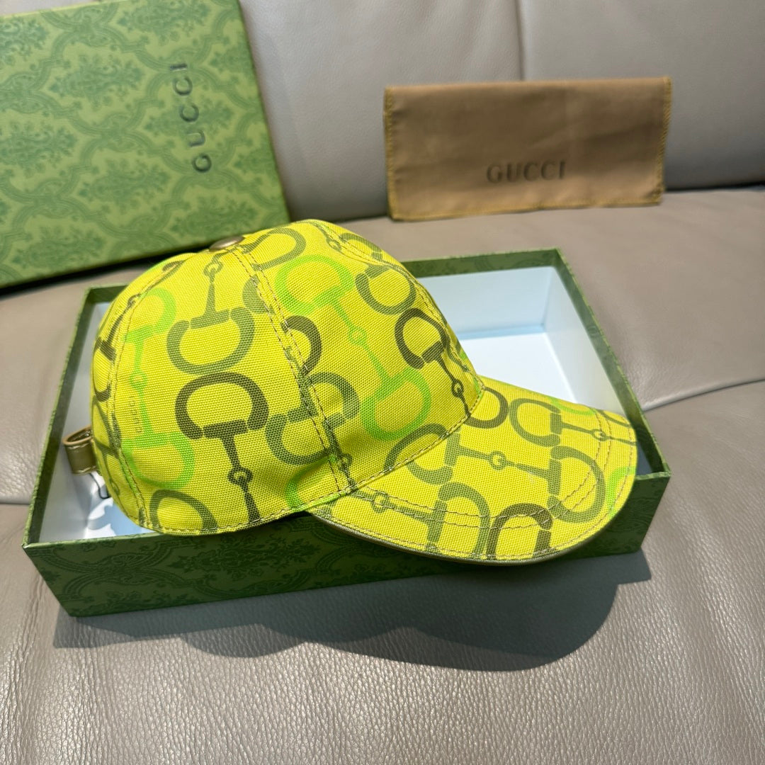 Yellow GG-print baseball cap with curved brim, front view.