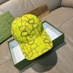 Yellow GG-print baseball cap with Gucci logo on front.