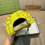 Yellow GG-print cap underside with strap and beige interior label.