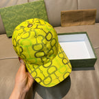 Yellow GG-print baseball cap with metal top button and curved brim.