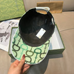 Baseball cap interior with black lining and green patterned brim