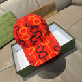 Gucci cap in red with black and orange logo links pattern, curved brim