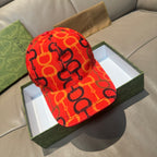 Gucci cap in red with black and orange logo links pattern, curved brim