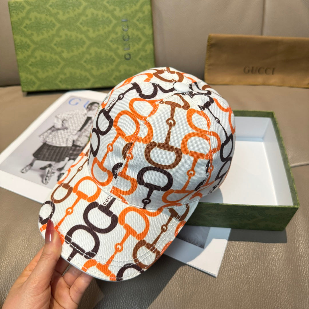 Gucci cap with orange and black link logo print over white fabric, curved brim.