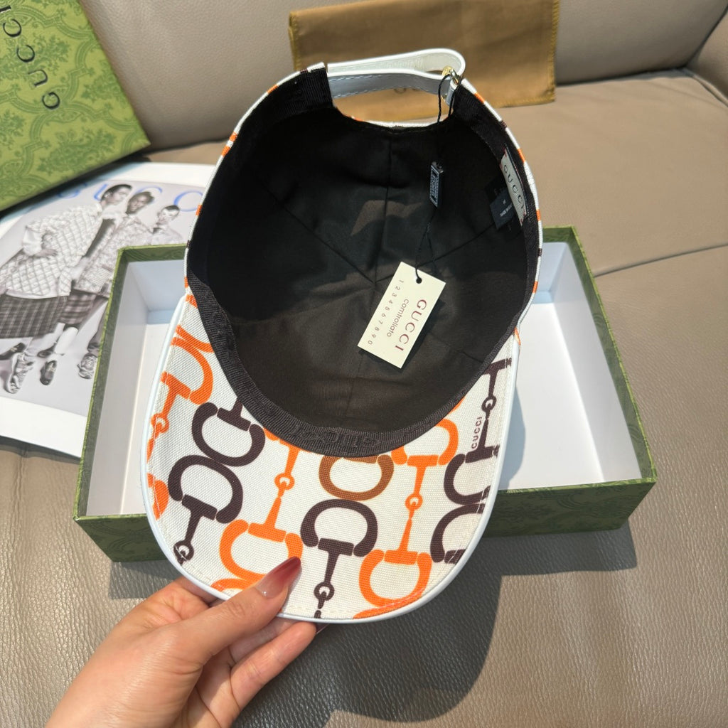 Gucci cap with black interior and white exterior featuring orange and black link logo.