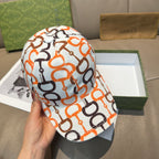 Gucci cap with white fabric and orange/black link logo pattern, curved brim.
