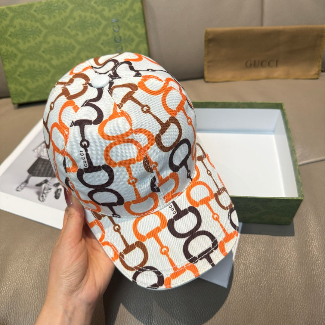 Gucci cap with white fabric and orange/black link logo pattern, curved brim.