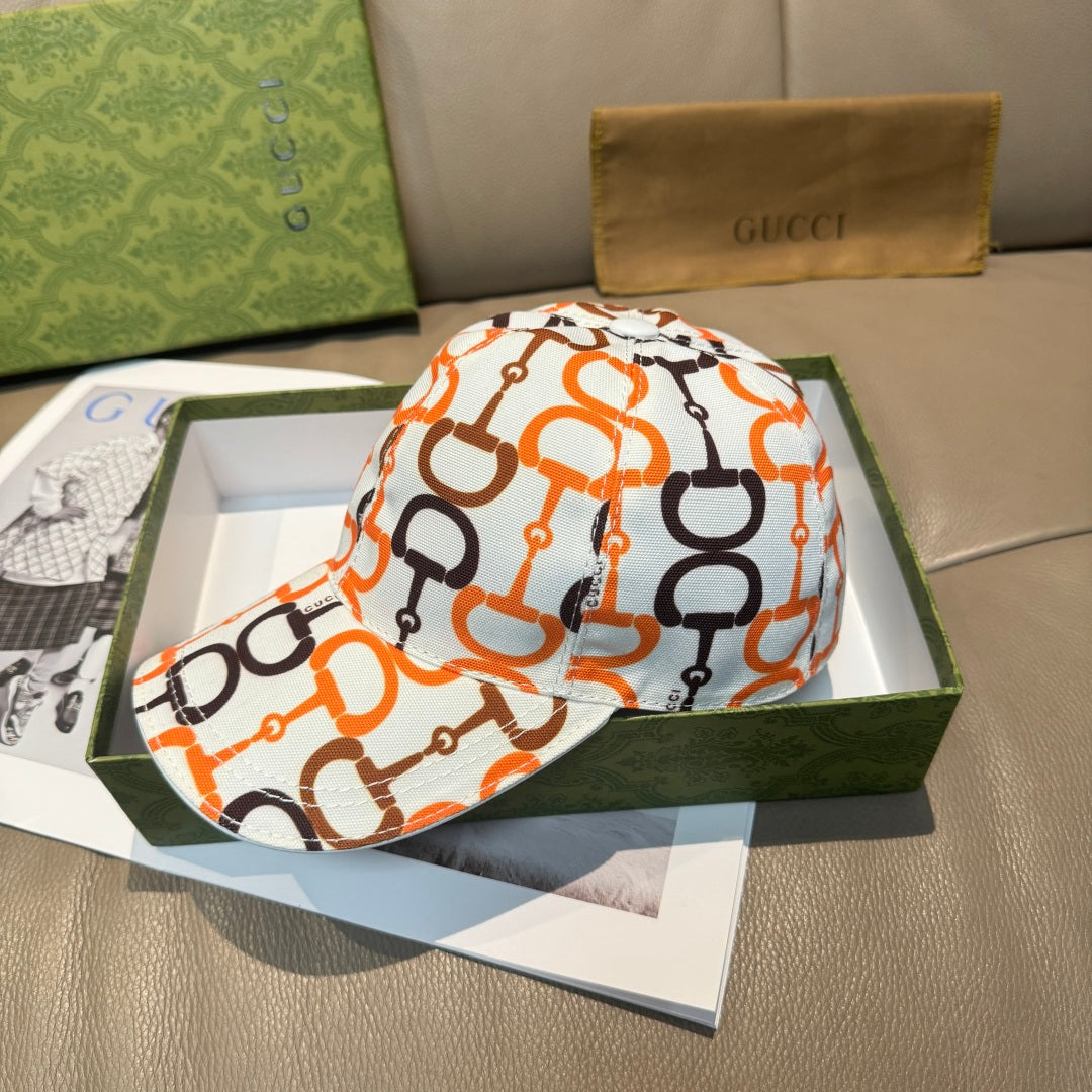 Gucci baseball cap with white, orange, and black link logo pattern, curved brim.