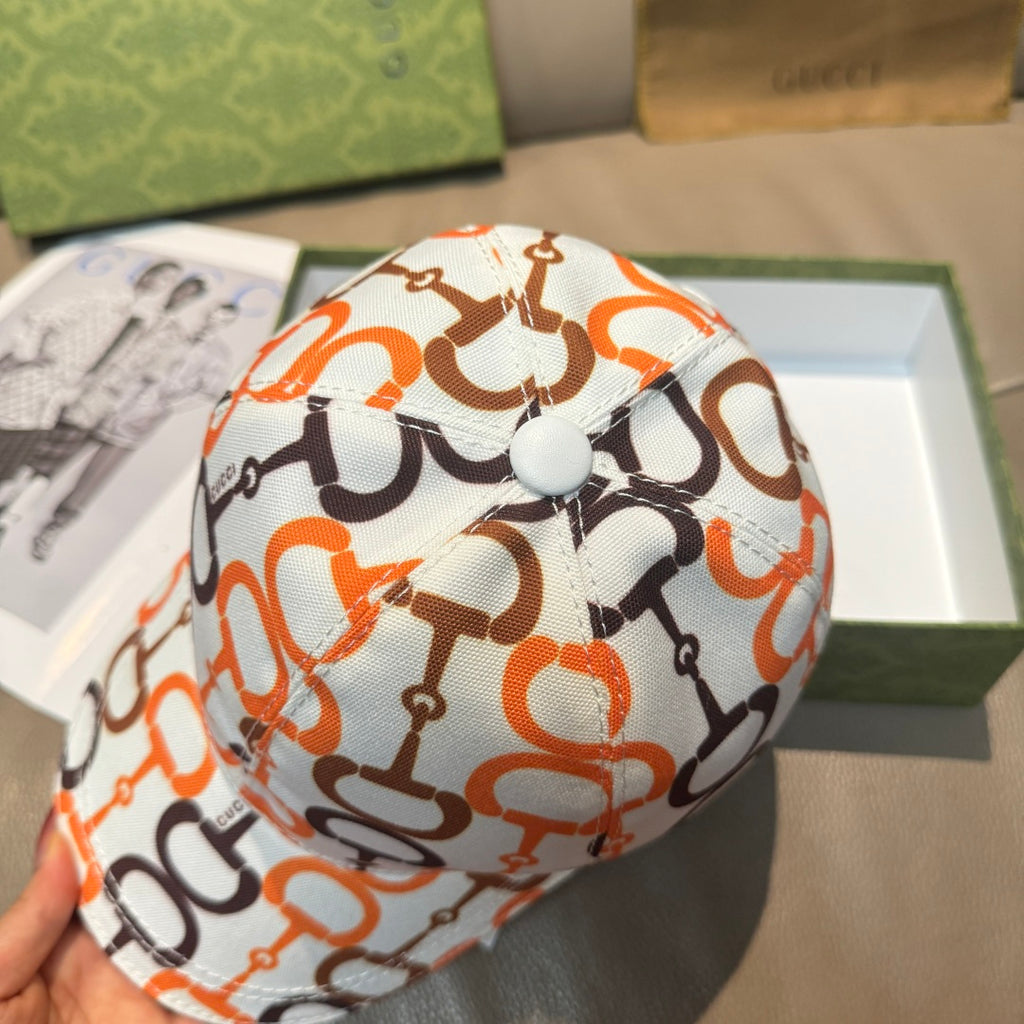 Gucci cap top button on white fabric with orange and black link logo print.