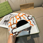 Gucci cap with white front patch and white fabric with orange and black link logo.