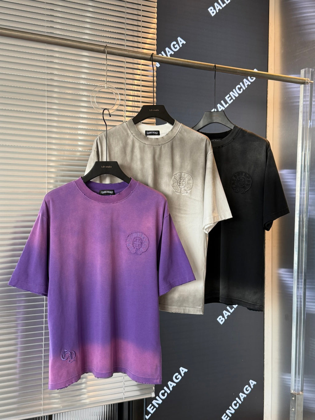 Crewneck short-sleeve T-shirts: cream, black, and purple with front crest embroidery