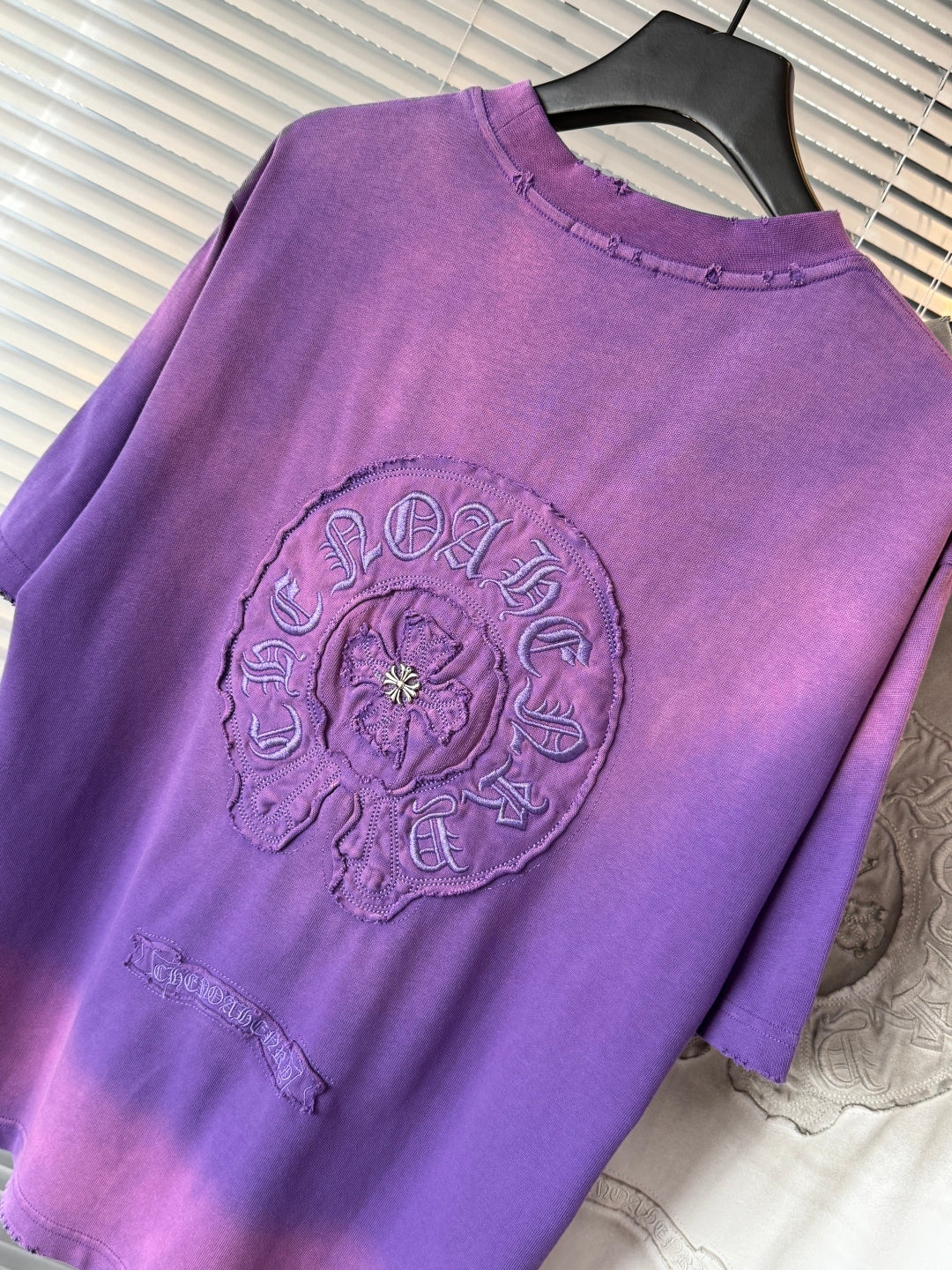 Crewneck short-sleeve T-shirt in purple with large circular crest graphic on chest