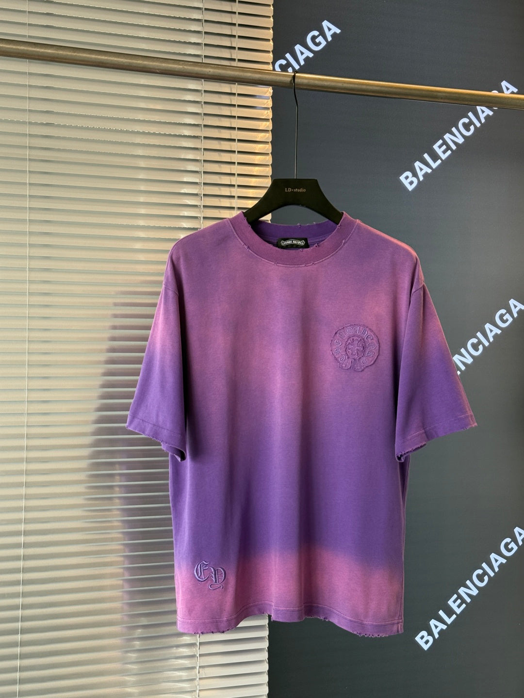 Purple crewneck short-sleeve T-shirt with small front crest graphic