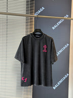 Black short-sleeve T-shirt with pink embroidered crest logo on the chest