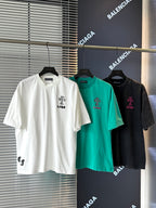 White short-sleeve T-shirt with black embroidered crest graphic on the chest