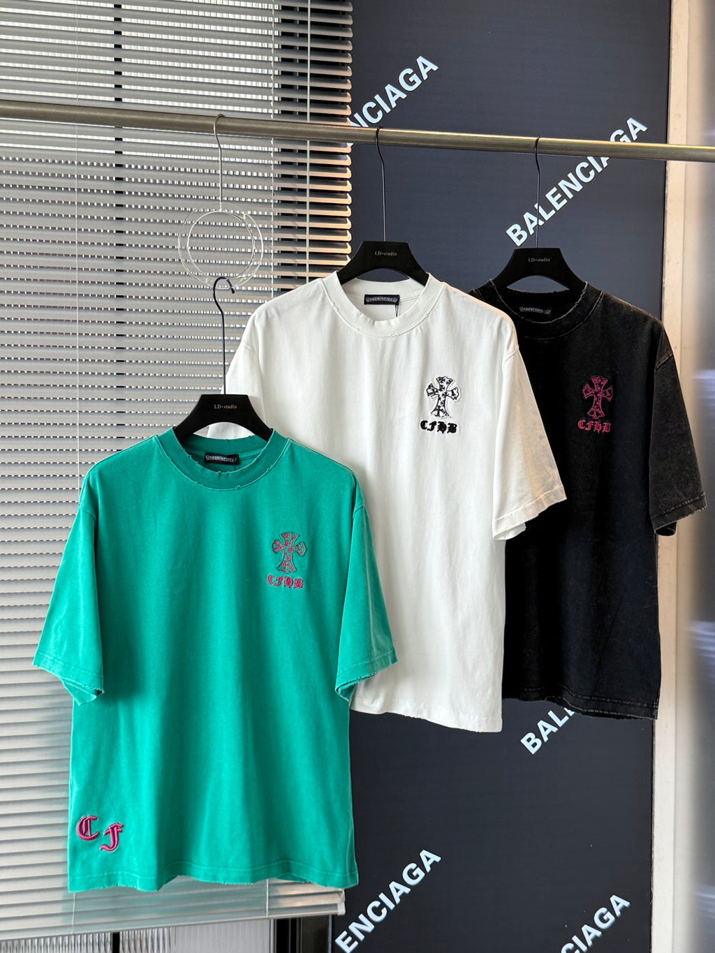 Turquoise, white, and black short-sleeve T-shirts with embroidered crest and small logo