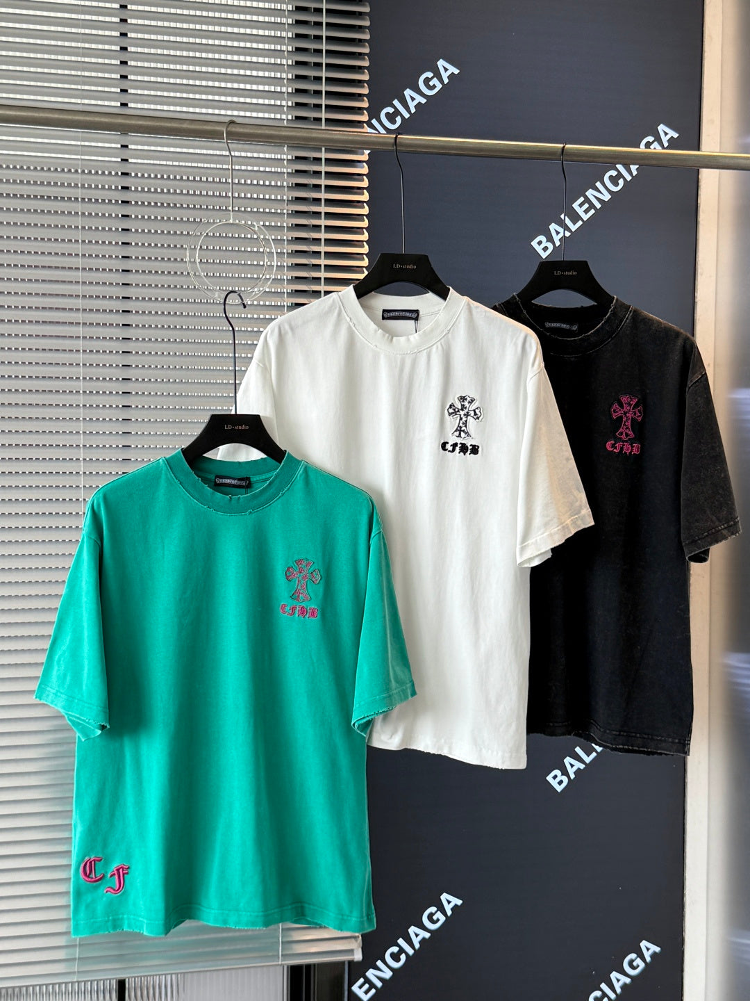 Turquoise, white, and black short-sleeve T-shirts with embroidered crest and small logo