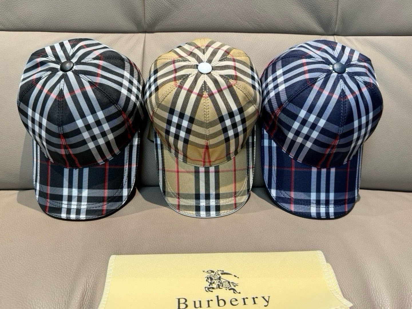 Set of three plaid baseball caps: black/red, beige/red, and navy/white