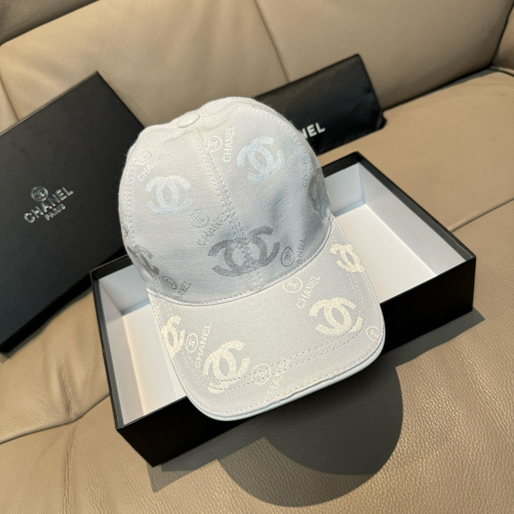 Chanel cap light white with allover CC logo pattern, curved brim, and round crown button