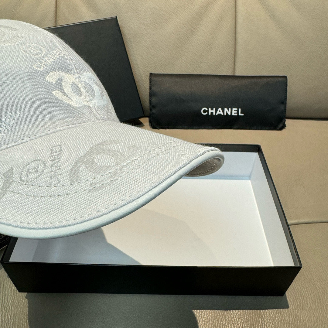 Chanel cap light white showing curved brim edge and CC logo fabric