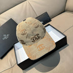 Beige Chanel cap with repeating logo pattern and dark top button