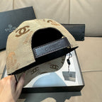 Beige Chanel cap with black underside brim and adjustable strap
