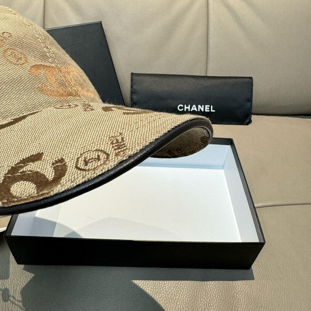 Beige Chanel cap brim detail with black trim on a presentation box