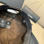 Black monogram cap with adjustable strap and gold-tone buckle