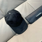 Dark monogram baseball cap with metal button detail and curved brim
