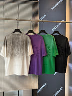 Short-sleeve T-shirts in off-white, purple, green, and black with small chest graphic