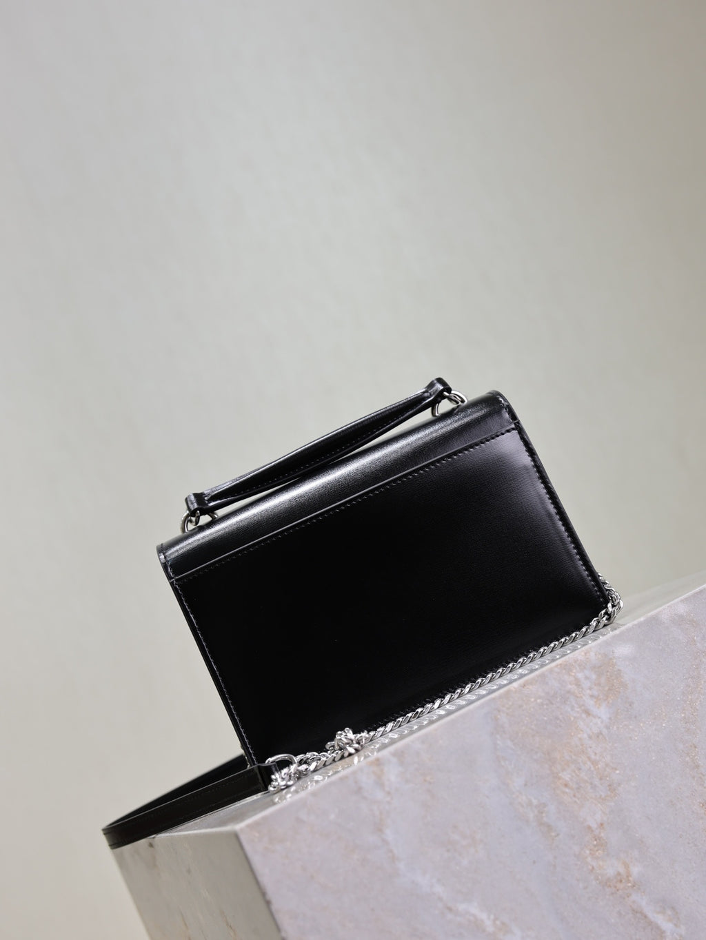 YSL black leather shoulder bag with flap, silver YSL logo and chain strap