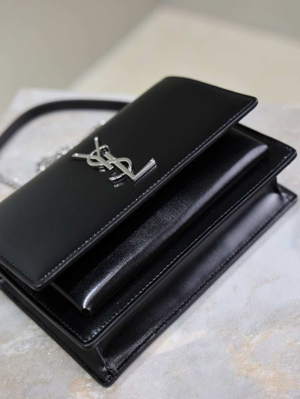 YSL black leather clutch bag with flap and silver YSL logo, chain strap