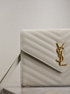 YSL quilted front flap bag in white with gold YSL logo and chevron stitching