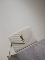 Women’s YSL small shoulder bag in white quilted chevron, gold YSL logo on flap