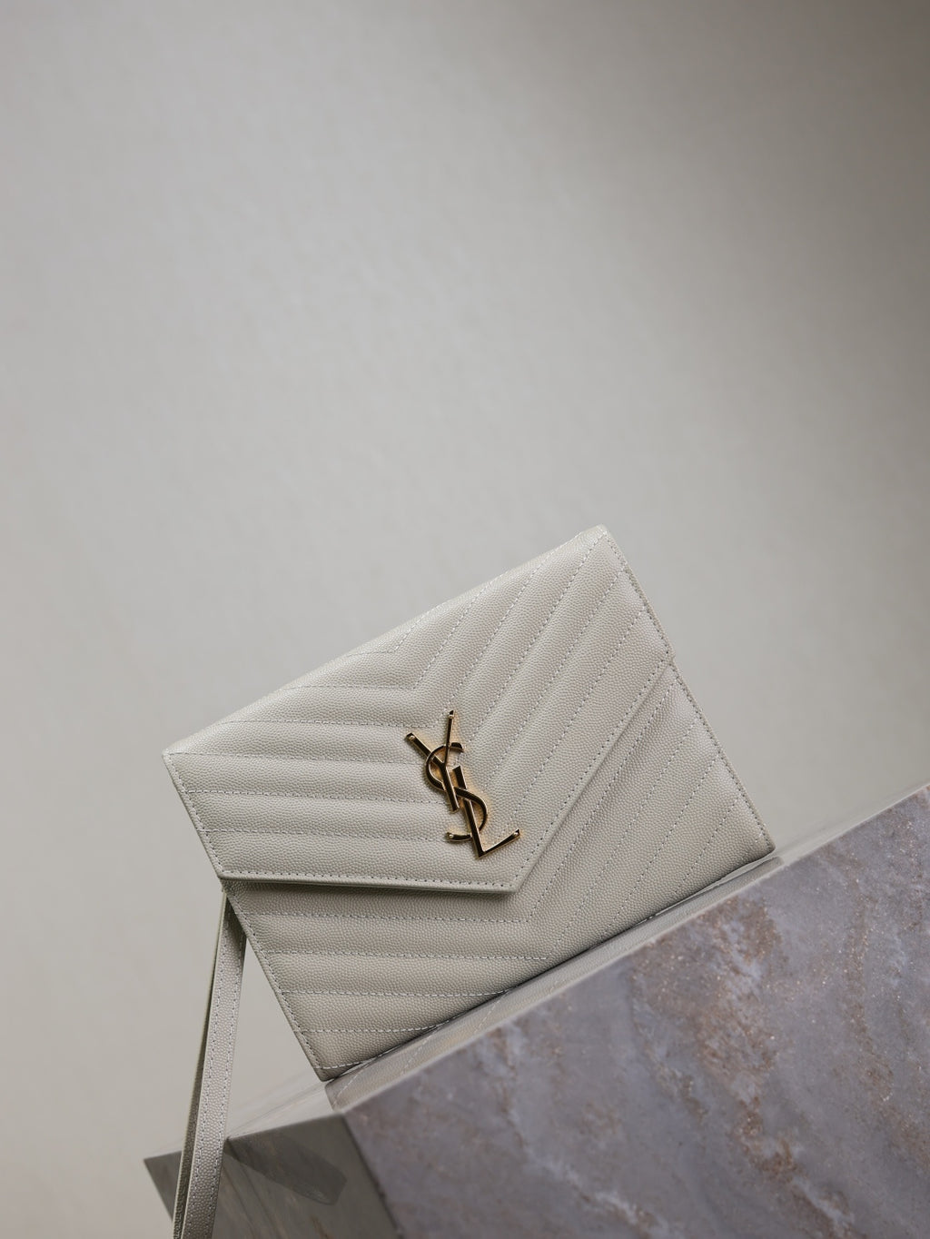 YSL flap shoulder bag in white, chevron quilting, gold YSL logo on front flap