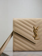 Beige quilted small YSL shoulder bag with front flap, YSL logo, and long strap