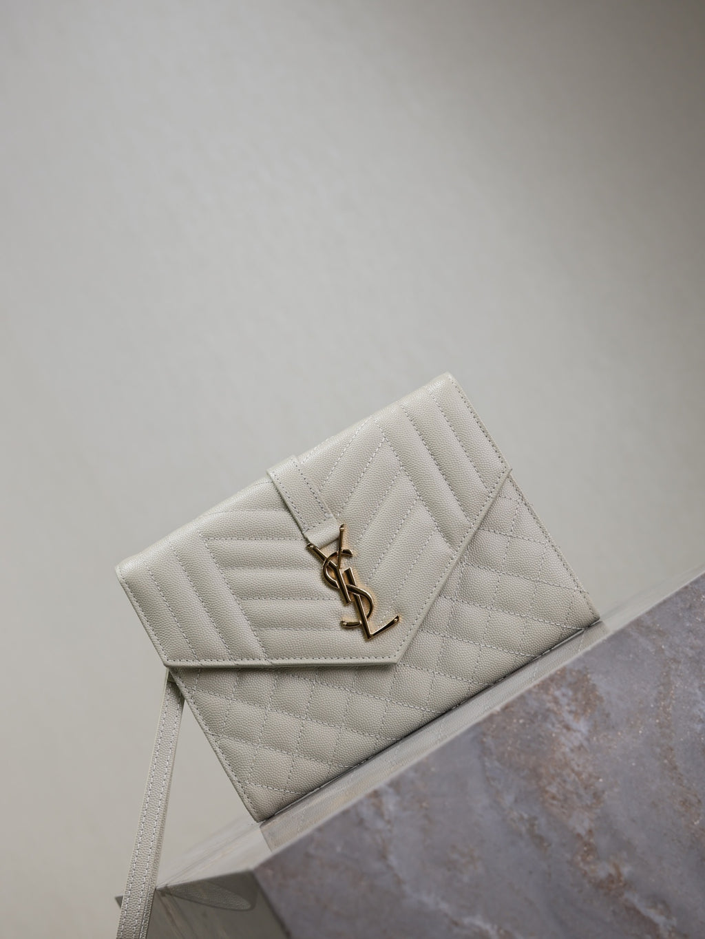 Small quilted YSL logo shoulder bag, diagonal stitch texture, light white.