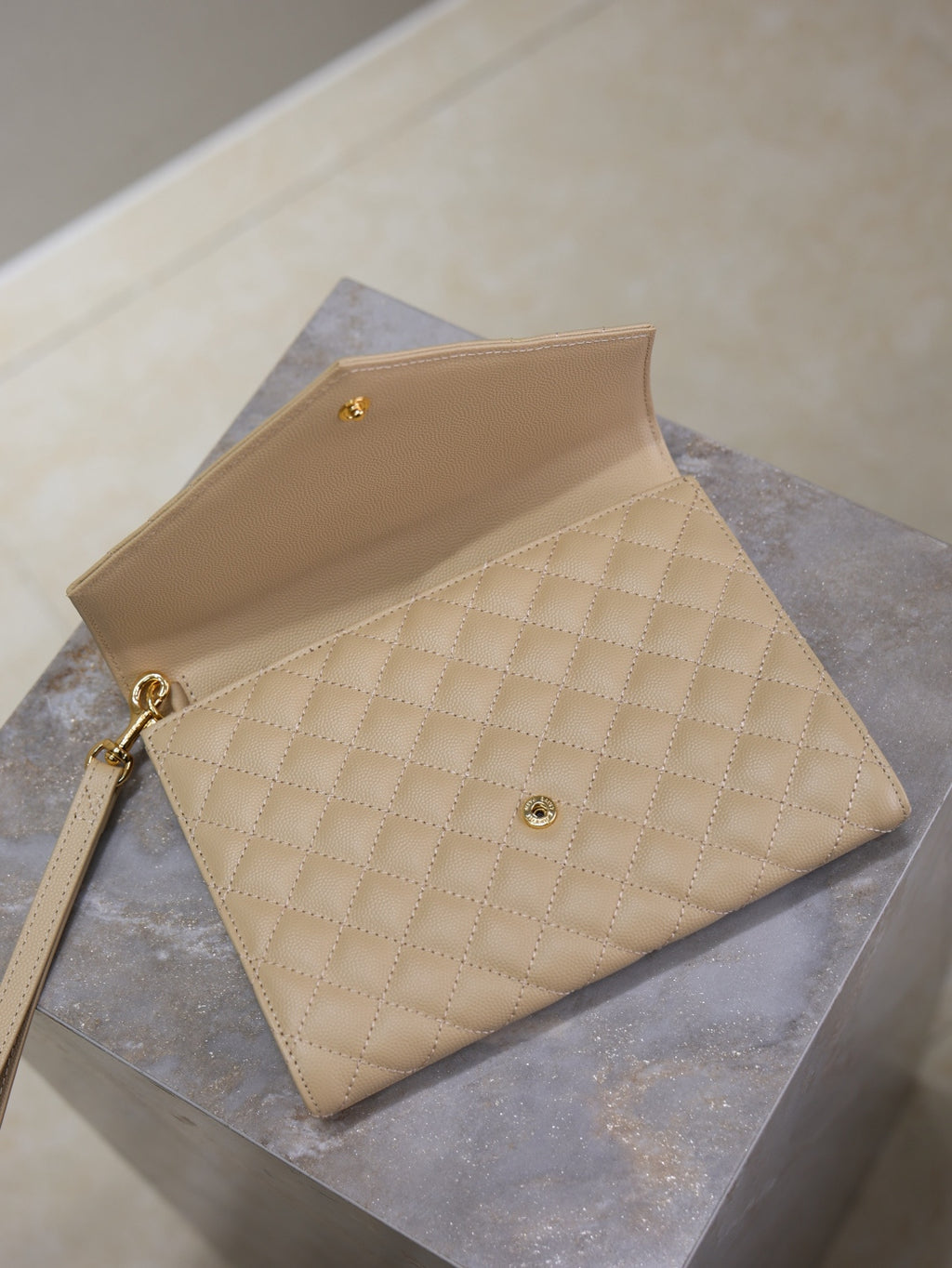 YSL quilted beige envelope flap bag with gold logo and crossbody strap
