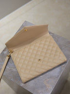 YSL quilted beige envelope flap bag with gold logo and crossbody strap